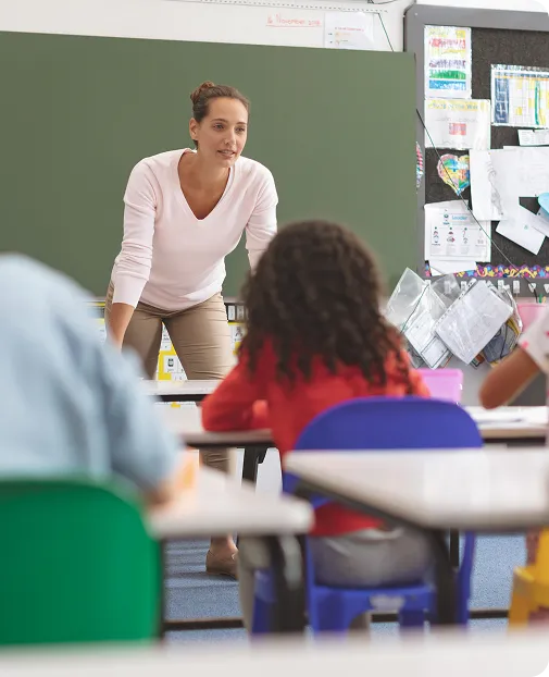 A teacher and student reviewing work on a tablet